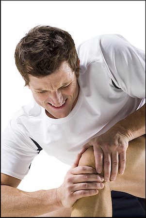 sports therapy - Man massaging a sore knee Stock Photo - Premium Royalty-Free, Code: 640-01360945