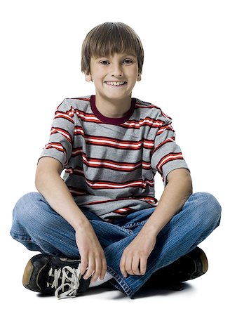 preteen boy happy white background - Portrait d'un garçon assis avec les jambes croisées Photographie de stock - Premium Libres de Droits, Code: 640-01360957
