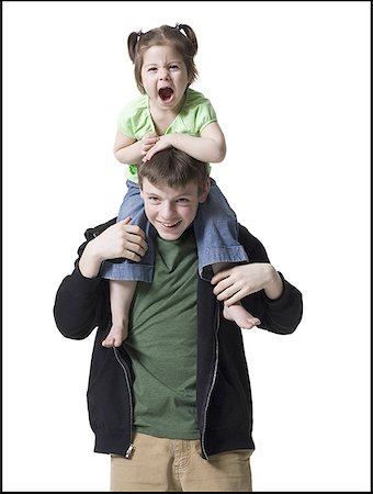 Portrait of a teenage boy carrying his sister on his shoulders Stock Photo - Premium Royalty-Free, Code: 640-01360958