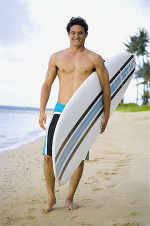 simsearch:640-01359819,k - Portrait of a young man holding a surfboard and walking on the beach Foto de stock - Sin royalties Premium, Código: 640-01361014