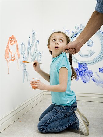 side profile jeans for girls - Close-up of a man pulling a girl's top while painting on a wall Foto de stock - Sin royalties Premium, Código: 640-01361010