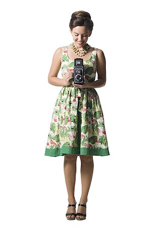 simsearch:640-01355807,k - Woman in floral dress holding antique camera Foto de stock - Sin royalties Premium, Código: 640-01361277