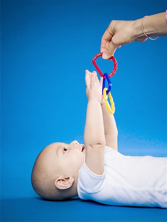 simsearch:640-01351279,k - Baby looking up at teething ring Stock Photo - Premium Royalty-Free, Code: 640-01361293