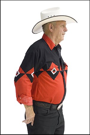 Older man in a western shirt with a cowboy hat Stock Photo - Premium Royalty-Free, Code: 640-01361349