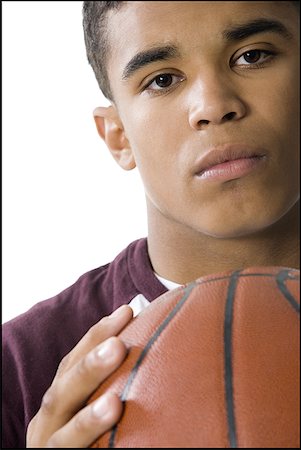 simsearch:640-01355296,k - Portrait of a young man holding a basketball Foto de stock - Sin royalties Premium, Código: 640-01361448