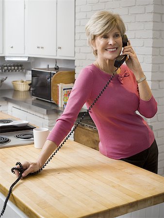 Mature woman talking on the telephone Stock Photo - Premium Royalty-Free, Code: 640-01361449
