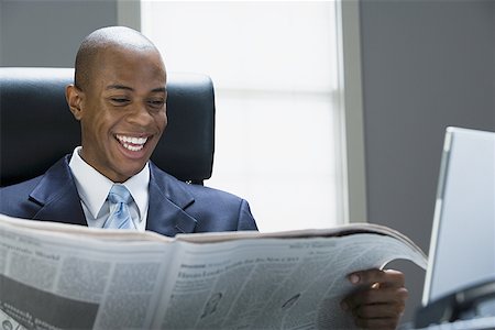 Businessman reading a newspaper Stock Photo - Premium Royalty-Free, Code: 640-01361461