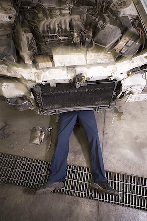 High angle view of a mechanic repairing a car Stock Photo - Premium Royalty-Free, Code: 640-01361514