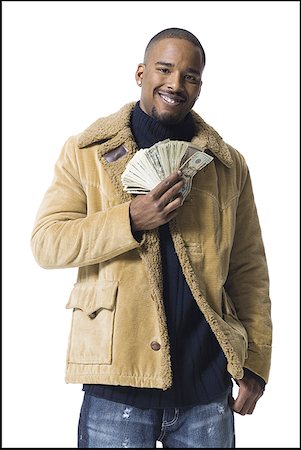 African American holding a pile of dollar bills Stock Photo - Premium Royalty-Free, Code: 640-01361597