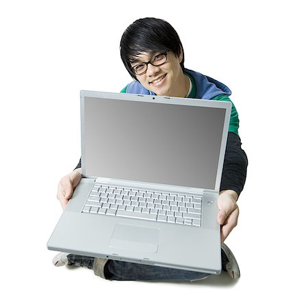 simsearch:640-01358649,k - Man with laptop sitting cross legged smiling Fotografie stock - Premium Royalty-Free, Codice: 640-01361608