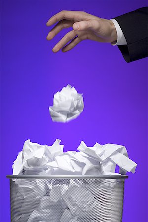 reversed - Close-up of a businessman's hand throwing a paper ball into a garbage bin Stock Photo - Premium Royalty-Free, Code: 640-01361617