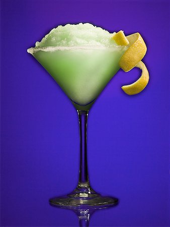 fruit garnish on cocktails - Green slush beverage in cocktail glass with lemon garnish Stock Photo - Premium Royalty-Free, Code: 640-01361669