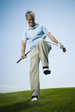 simsearch:640-01356786,k - Low angle view of a man breaking a golf club Foto de stock - Sin royalties Premium, Código: 640-01361672