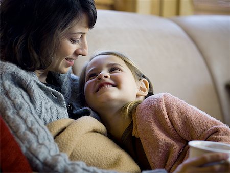simsearch:640-01601434,k - Woman with young girl snuggling on sofa Stock Photo - Premium Royalty-Free, Code: 640-01361686