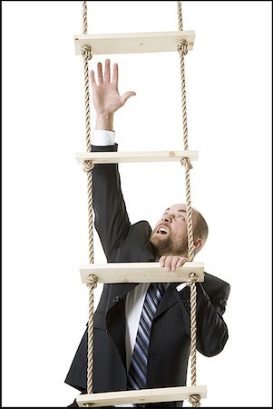 Close-up of a businessman climbing a ladder Stock Photo - Premium Royalty-Free, Code: 640-01361707