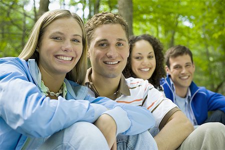 Portrait of two young women and two young men sitting and smiling Stock Photo - Premium Royalty-Free, Code: 640-01361749