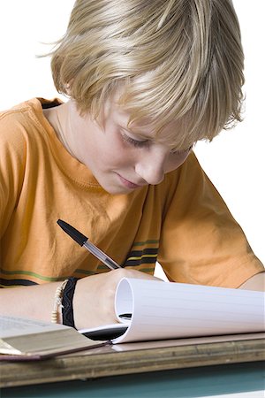 Close-up of a boy doing homework Stock Photo - Premium Royalty-Free, Code: 640-01361741