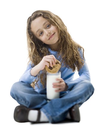 slam dunk - Portrait of a girl dipping a cookie into a glass of milk Stock Photo - Premium Royalty-Free, Code: 640-01361777