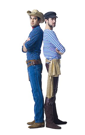 Man in cowboy costume and man in leather pants with waist sash standing back to back Foto de stock - Sin royalties Premium, Código: 640-01361952