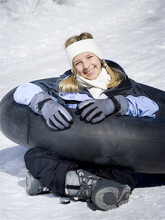 sitting inner tube - Portrait of a girl sitting on the snow with an inner tube Stock Photo - Premium Royalty-Free, Code: 640-01362121