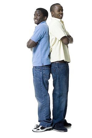 Portrait of two brothers standing back to back Stock Photo - Premium Royalty-Free, Code: 640-01362158