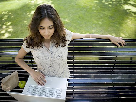 High angle view of a young woman using a laptop Stock Photo - Premium Royalty-Free, Code: 640-01362168