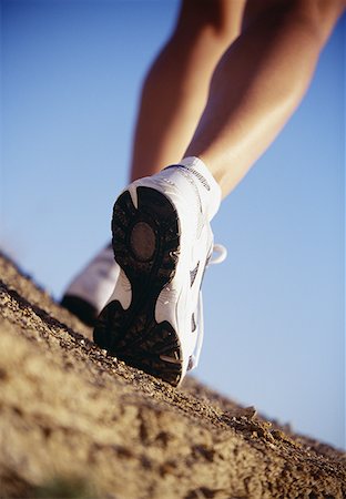 sole of shoe - Low section view of a person walking wearing sports shoes Stock Photo - Premium Royalty-Free, Code: 640-01362194