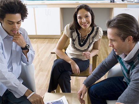 simsearch:695-03376535,k - Three office workers having a meeting Stock Photo - Premium Royalty-Free, Code: 640-01362236