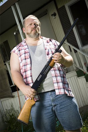 redneck facial hair - Overweight man with a shotgun Stock Photo - Premium Royalty-Free, Code: 640-01362265