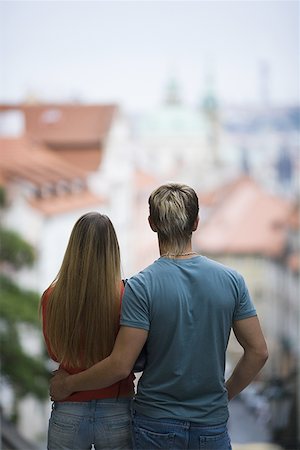 person standing back building street - Rear view of a young man standing with a young woman Stock Photo - Premium Royalty-Free, Code: 640-01362346