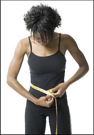 simsearch:640-01353414,k - Close-up of a young woman measuring her waist Stock Photo - Premium Royalty-Free, Code: 640-01362436