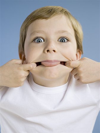 Portrait of boy sticking tongue out Stock Photo - Premium Royalty-Free, Code: 640-01362454