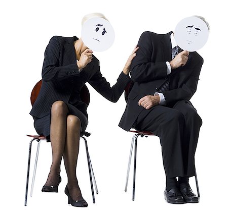 Businessman and businesswoman holding expression masks Stock Photo - Premium Royalty-Free, Code: 640-01362480