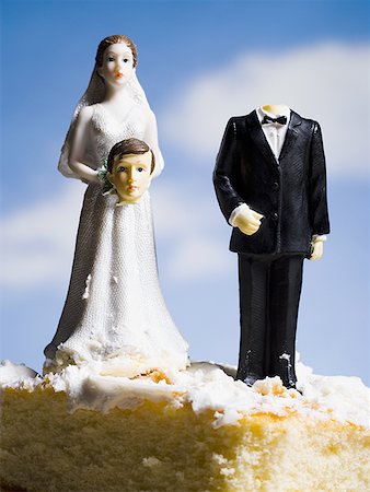 photo of a husband abusing wife - Wedding cake visual metaphor with figurine cake toppers Stock Photo - Premium Royalty-Free, Code: 640-01362491
