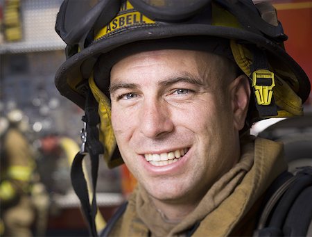 firemen uniform - Close-up of a firefighter wearing a helmet Stock Photo - Premium Royalty-Free, Code: 640-01362550