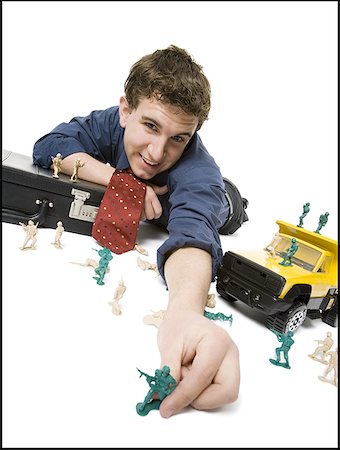 figurines businessman - Portrait of a businessman playing with toys Stock Photo - Premium Royalty-Free, Code: 640-01362588