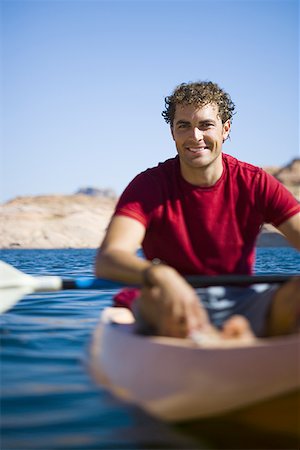 Portrait of a young man sitting in a kayak Stock Photo - Premium Royalty-Free, Code: 640-01362609