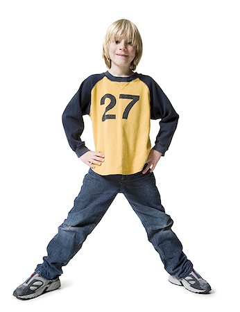 Portrait of a boy standing with hands on hips Stock Photo - Premium Royalty-Free, Code: 640-01362625