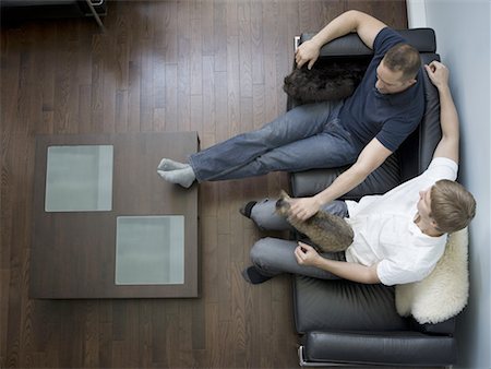 High angle view of two men sitting on a couch Stock Photo - Premium Royalty-Free, Code: 640-01362634