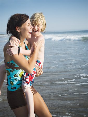 females under 16 years old - Young woman with little brother at beach Stock Photo - Premium Royalty-Free, Code: 640-01362678