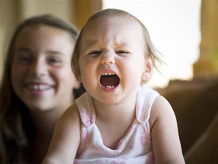 portrait screaming girl - Young girl and her baby sister Stock Photo - Premium Royalty-Free, Code: 640-01362775