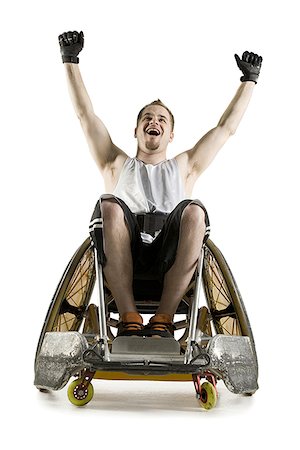 Low angle view of a young man with his arms raised Stock Photo - Premium Royalty-Free, Code: 640-01362792