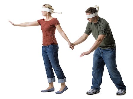 Blindfolded young woman leading to a blindfolded young man Fotografie stock - Premium Royalty-Free, Codice: 640-01362809