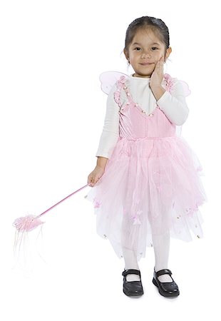 Portrait d'une jeune fille habillé dans un costume de fée tenant une baguette magique Photographie de stock - Premium Libres de Droits, Code: 640-01362848