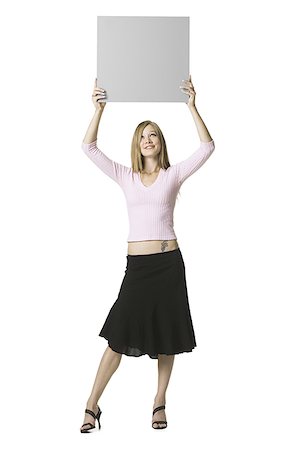 simsearch:640-01362473,k - Young woman holding a blank sign Foto de stock - Sin royalties Premium, Código: 640-01362893