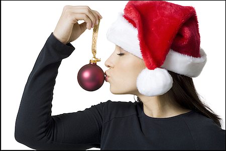 Close-up of a young woman kissing a Christmas ornament Stock Photo - Premium Royalty-Free, Code: 640-01362983