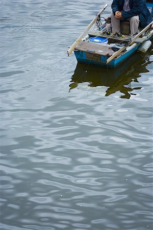 High angle view of a man in a boat Stock Photo - Premium Royalty-Free, Code: 640-01363013