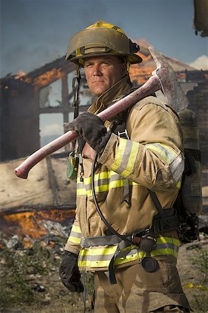 fireman portrait - Portrait of a firefighter holding an axe Stock Photo - Premium Royalty-Free, Code: 640-01363026