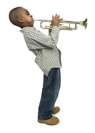 Profile of a boy blowing a trumpet Foto de stock - Sin royalties Premium, Código: 640-01363053