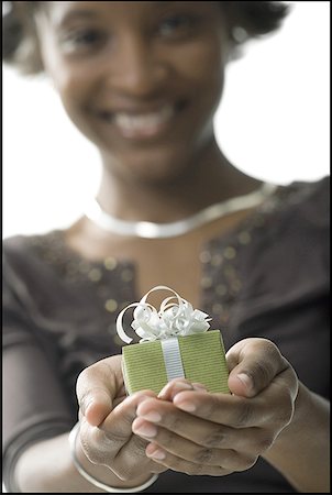 Portrait of a young woman holding a gift Stock Photo - Premium Royalty-Free, Code: 640-01363089